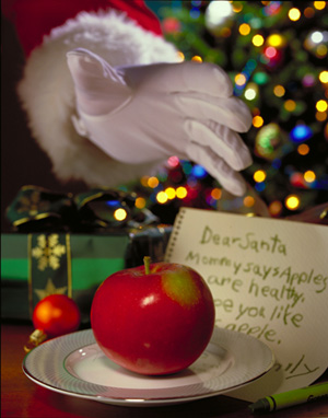 Santa Claus reaching for an apple in an Apple Growers Association public-relations campaign