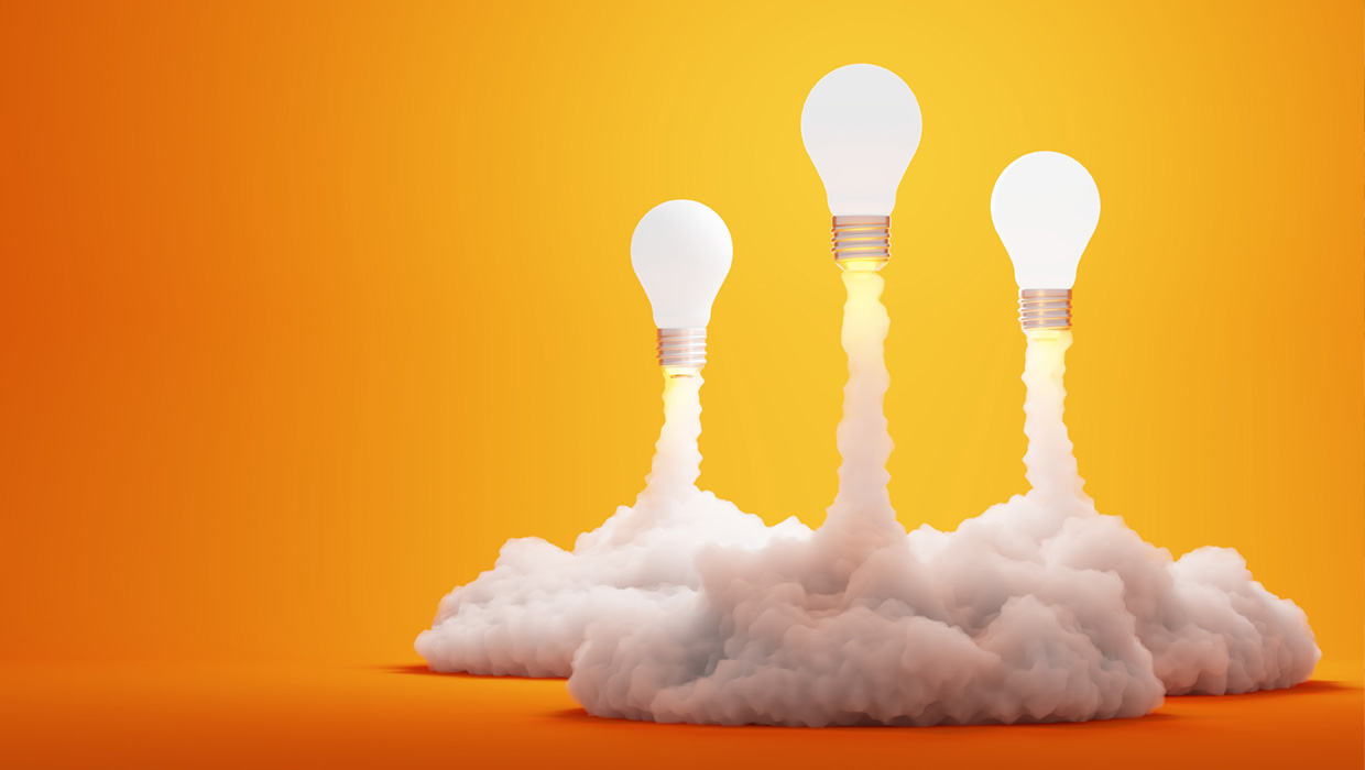 symbolic image depicting creativity with three glowing lightbulbs taking off like rockets