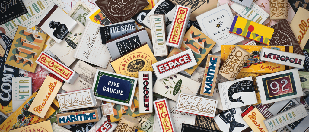 Pile of matchboxes with handlettered designs