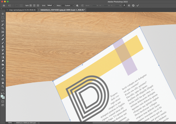 Photoshop screen shows placed document page, with contours of top edge adjusted via Bézier curves (top left corner active) to make page dimensions hew to uneven perspective of blank document in photo. 