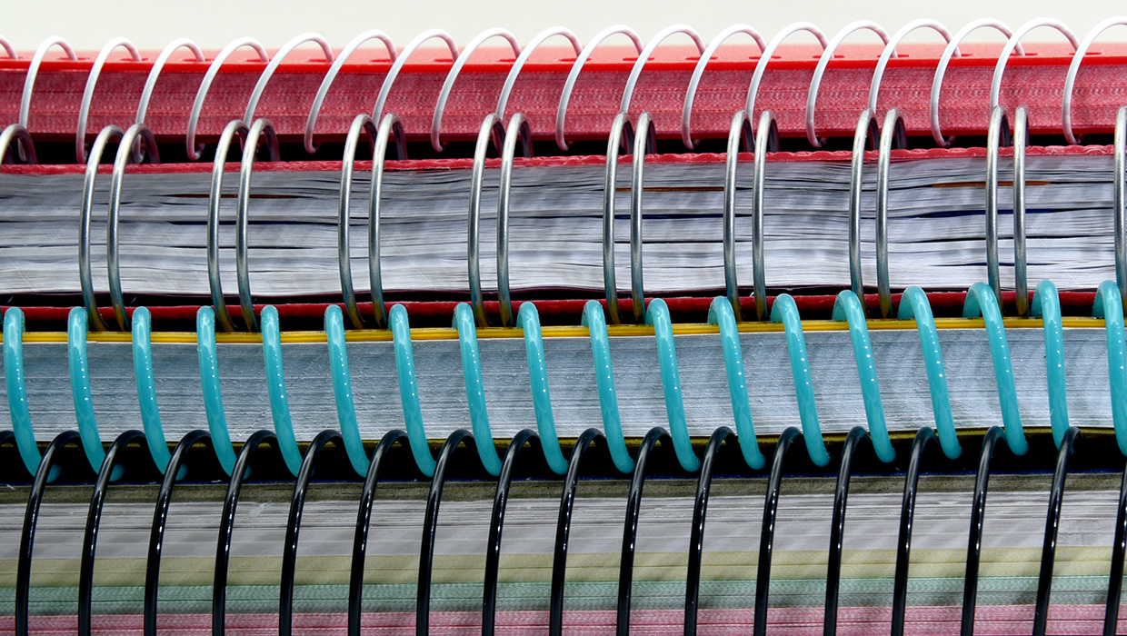 a stack of spiral bound books