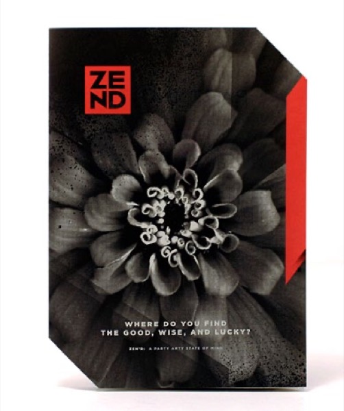 Brochure with black-and-white photo of a flower, with logo ZEND in red in upper left and red decorative stripe down right edge. Top right corner is cut off, as is bottom left corner. "Where do you find the good, wise, and lucky?" text in white on photo.