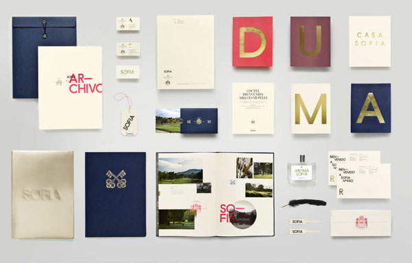 Photo shows collection of printed collateral and products like cologne.